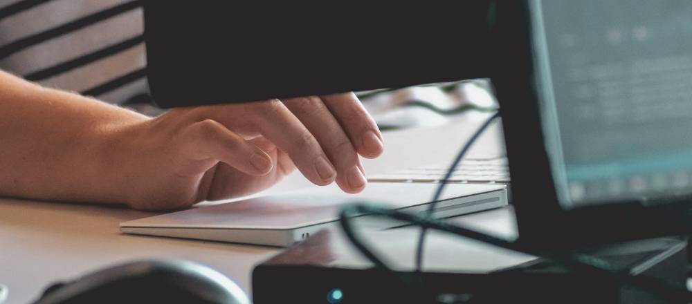 Women compiling her Important Documentation to Move Internationally on a computer.