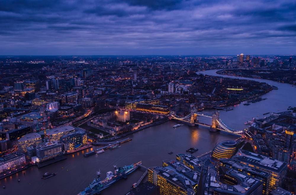 View of London with Tower Bridge and city lights in the background.